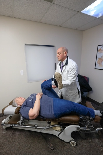 Chiropractor stretching a patient's back